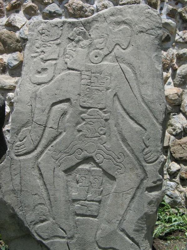 Ancient Zapotec stela carved with figures and glyphs at Monte Albán